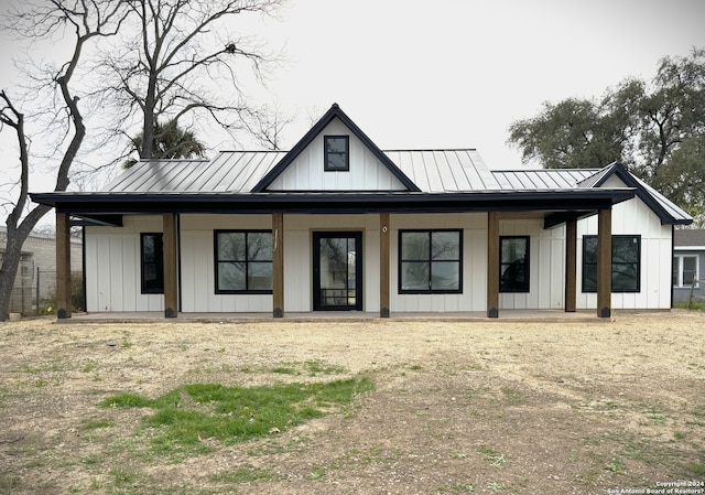 back of house featuring covered porch