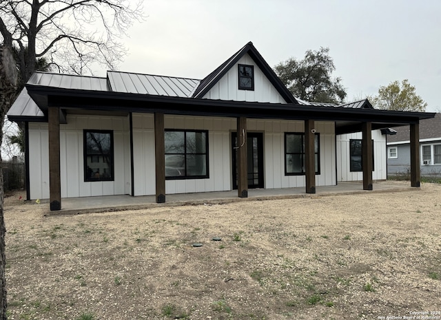 rear view of property featuring a porch