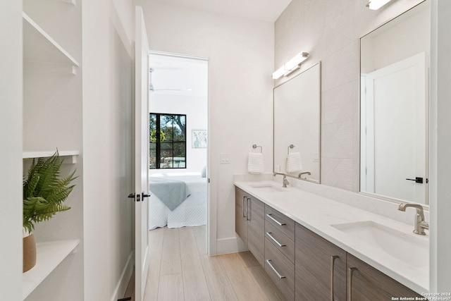 bathroom featuring double sink vanity and wood-type flooring