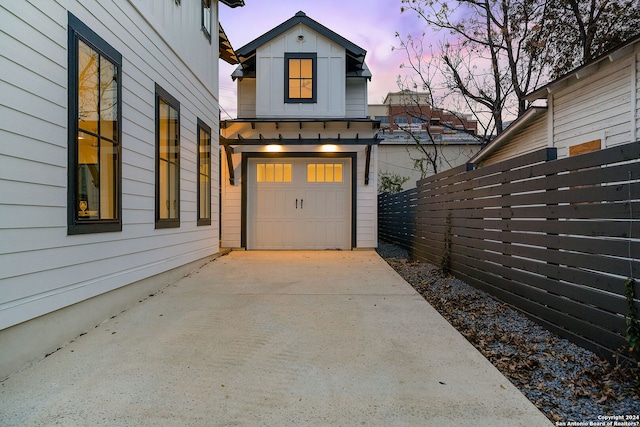 view of garage at dusk