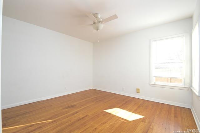 empty room with ceiling fan and hardwood / wood-style flooring