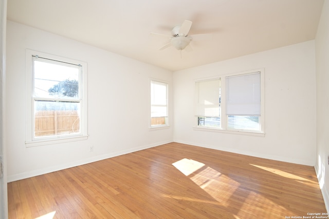 unfurnished room with ceiling fan and light wood-type flooring