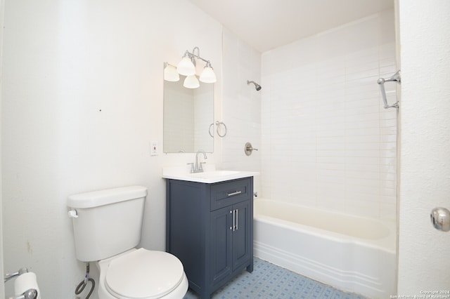 full bathroom featuring tiled shower / bath, toilet, tile floors, and vanity