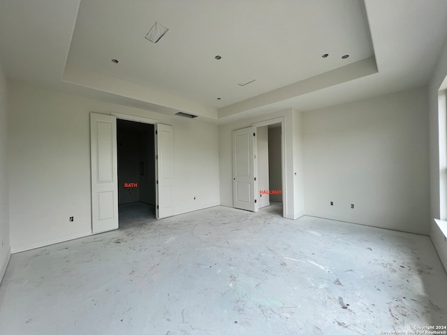 unfurnished bedroom featuring a tray ceiling