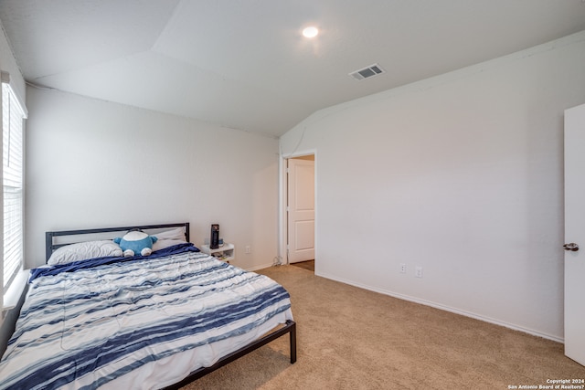 bedroom with light carpet and vaulted ceiling