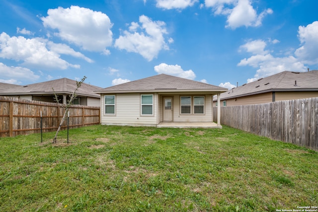 back of property featuring a yard and a patio