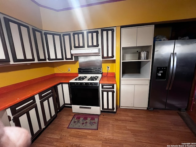 kitchen with stainless steel fridge with ice dispenser, premium range hood, dark hardwood / wood-style floors, and white gas range