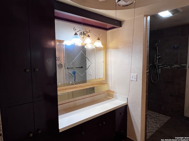 bathroom with a tile shower and oversized vanity