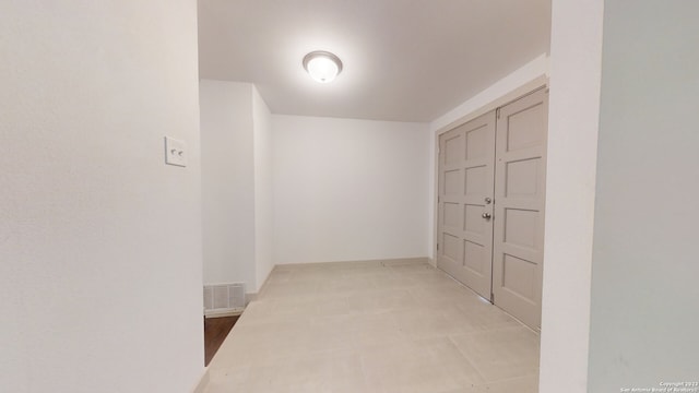 corridor with light tile flooring