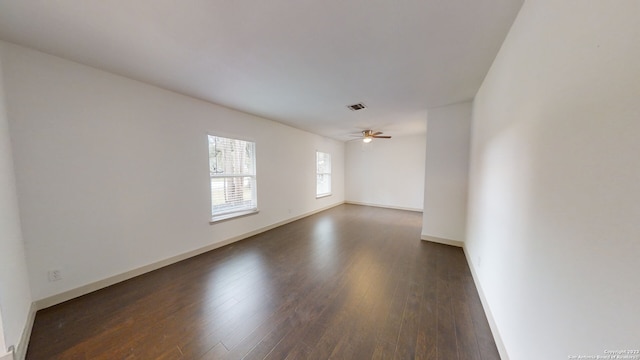 spare room with ceiling fan and dark hardwood / wood-style floors