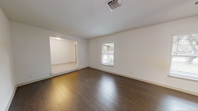 empty room with dark wood-type flooring