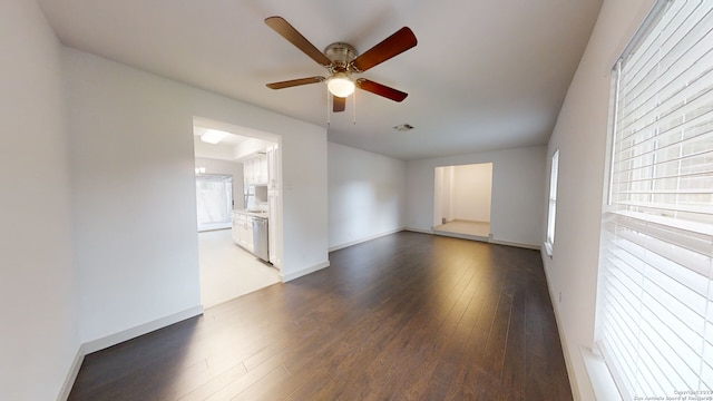 spare room with ceiling fan and dark hardwood / wood-style floors