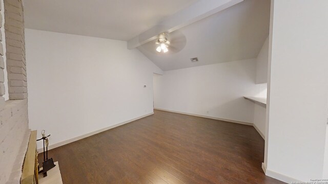 unfurnished room with ceiling fan, brick wall, dark wood-type flooring, and lofted ceiling with beams