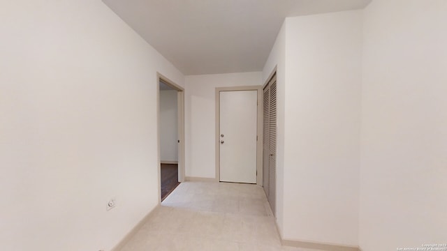 hall featuring light tile floors