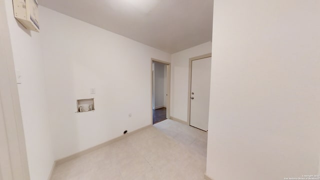 laundry room featuring washer hookup and light tile flooring