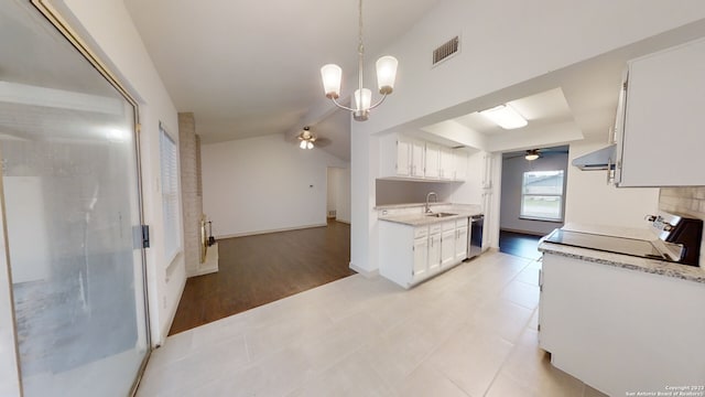 kitchen featuring sink, stove, dishwashing machine, ceiling fan with notable chandelier, and white cabinetry