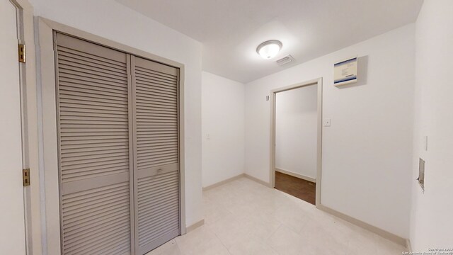 hallway featuring light tile floors