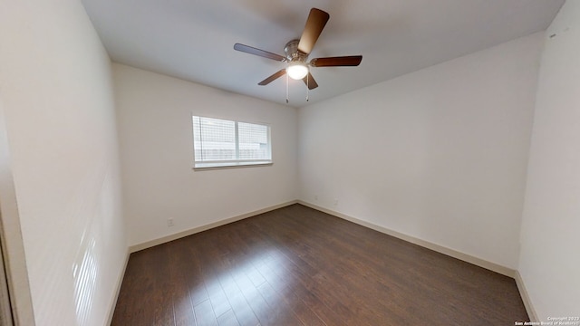 empty room featuring dark hardwood / wood-style flooring and ceiling fan