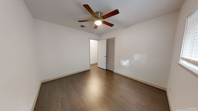 unfurnished room featuring ceiling fan and dark hardwood / wood-style flooring