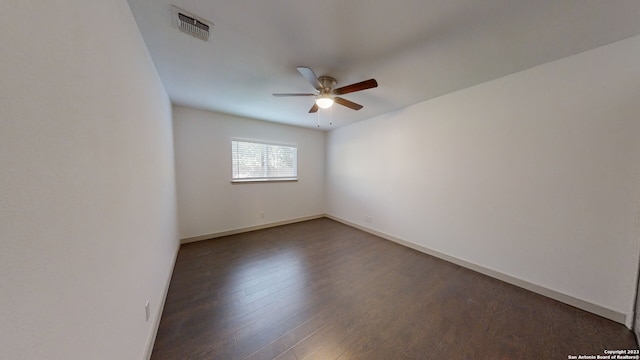 spare room featuring ceiling fan and dark hardwood / wood-style flooring