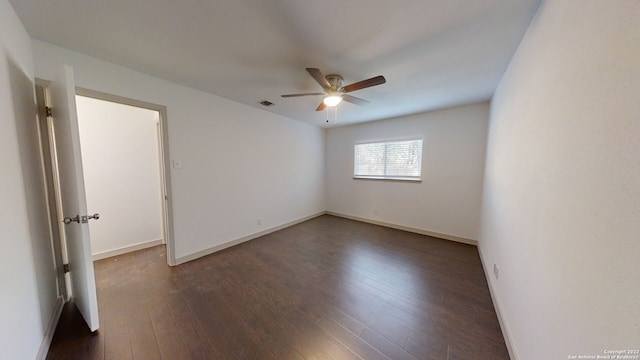 unfurnished room featuring dark wood-type flooring and ceiling fan