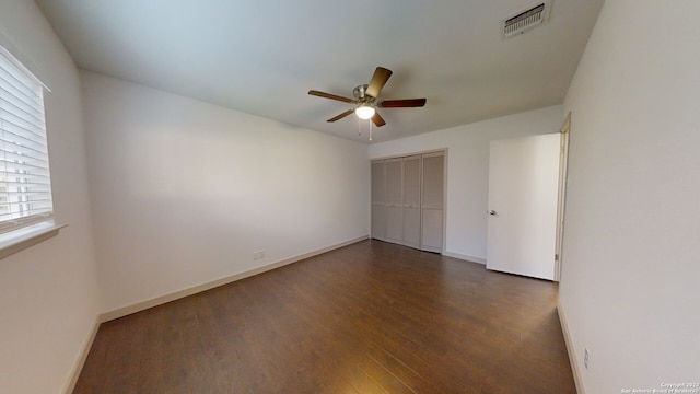 unfurnished room featuring ceiling fan and dark hardwood / wood-style flooring