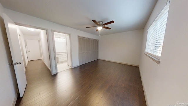 unfurnished bedroom featuring ensuite bathroom, a closet, ceiling fan, and dark hardwood / wood-style flooring