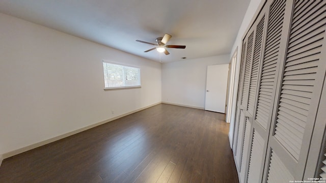 unfurnished bedroom with dark hardwood / wood-style flooring and ceiling fan