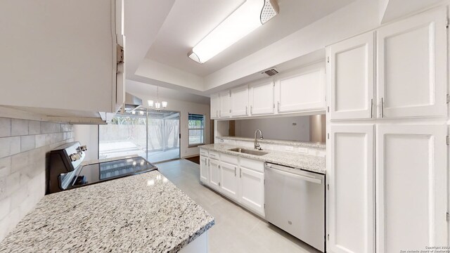 kitchen featuring a chandelier, dishwasher, white cabinetry, range, and sink