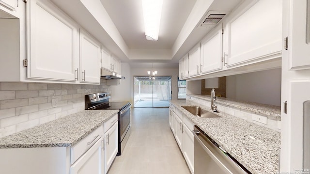 kitchen with a notable chandelier, electric range, tasteful backsplash, white cabinetry, and sink