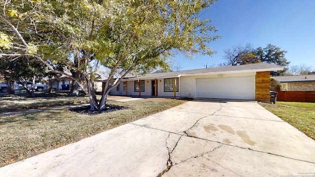 ranch-style house featuring a front lawn and a garage