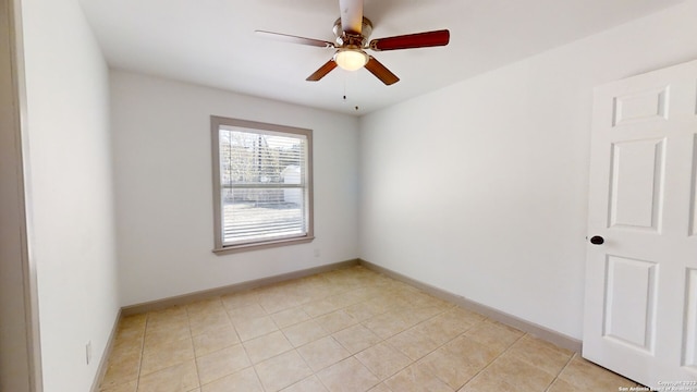 tiled spare room with ceiling fan