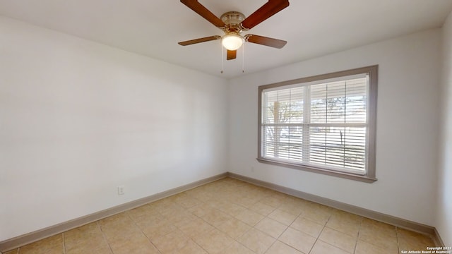 empty room with light tile floors and ceiling fan