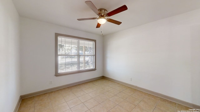 tiled empty room with ceiling fan