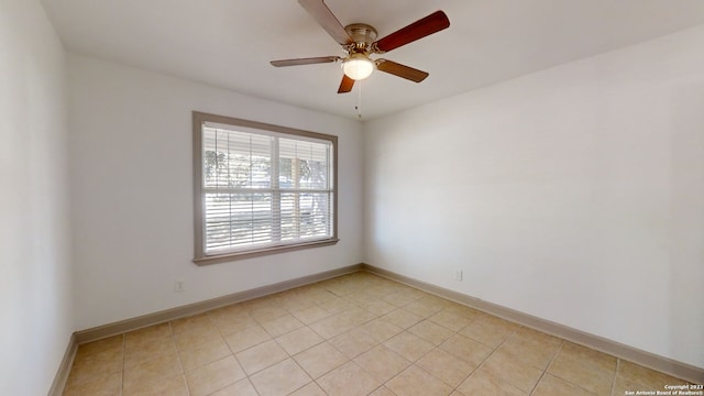 unfurnished room featuring ceiling fan and light tile flooring