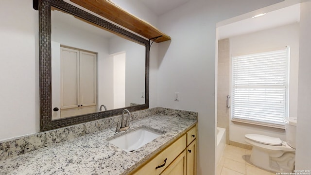 bathroom featuring vanity, tile flooring, and toilet