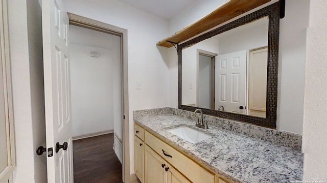 bathroom with oversized vanity and hardwood / wood-style floors