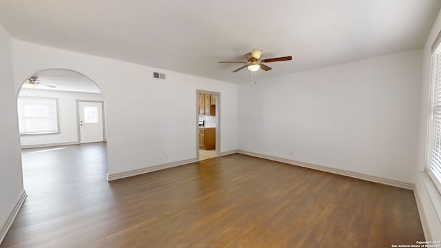 spare room with dark hardwood / wood-style flooring and ceiling fan