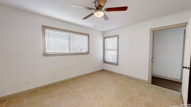 tiled empty room with ceiling fan