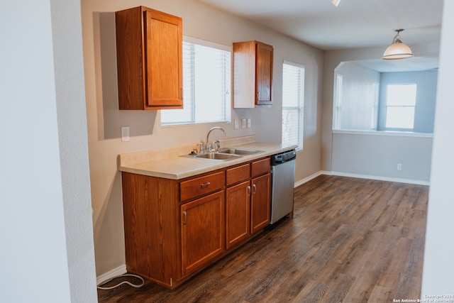 kitchen with decorative light fixtures, a healthy amount of sunlight, dark hardwood / wood-style floors, and dishwasher