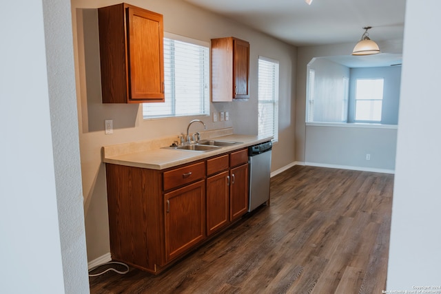 kitchen featuring stainless steel dishwasher, dark wood-type flooring, a healthy amount of sunlight, hanging light fixtures, and sink