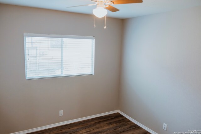 spare room with ceiling fan and dark hardwood / wood-style flooring