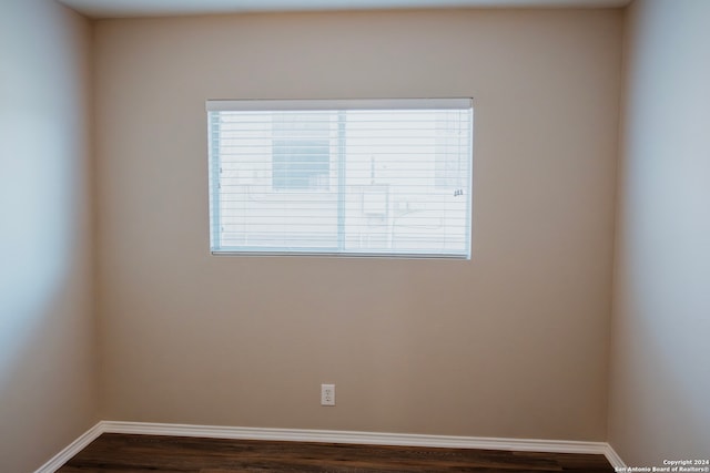 empty room with dark hardwood / wood-style floors