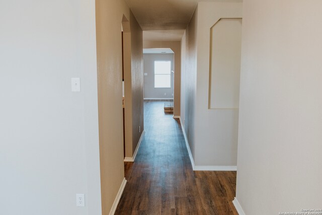 corridor featuring dark wood-type flooring