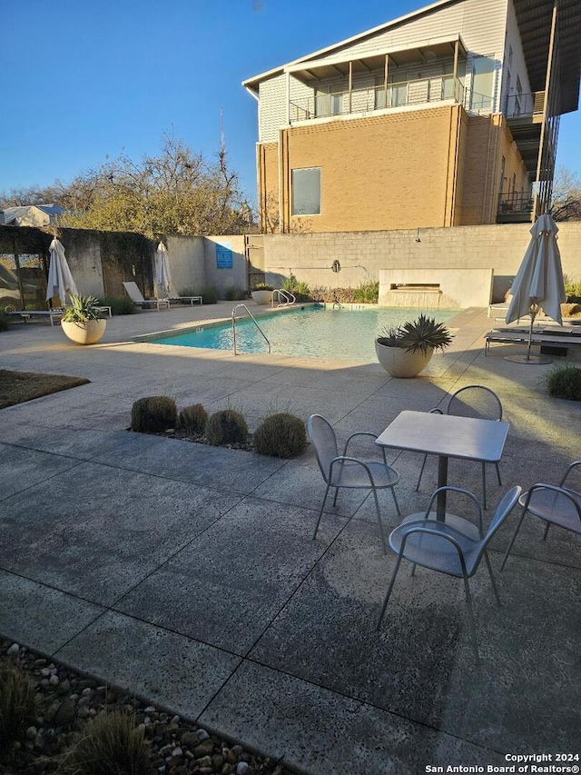 view of swimming pool with a patio area