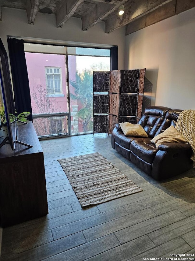 living room with beam ceiling and dark hardwood / wood-style flooring