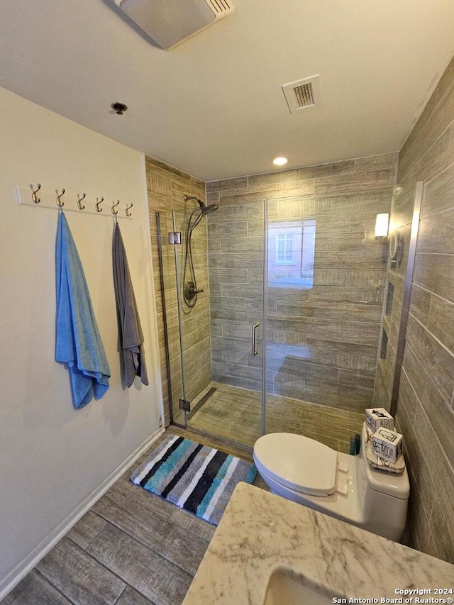 bathroom with walk in shower, tile walls, and toilet