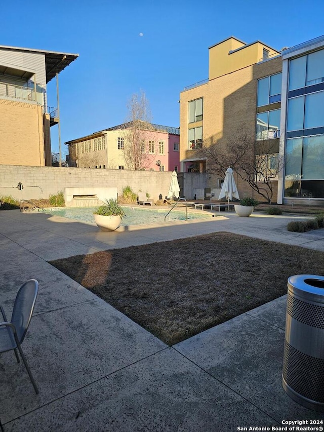 view of yard with central AC and a patio