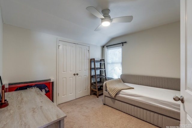 carpeted bedroom featuring a closet, lofted ceiling, and ceiling fan