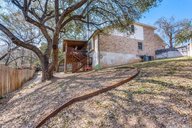 back of property with central air condition unit and a wooden deck